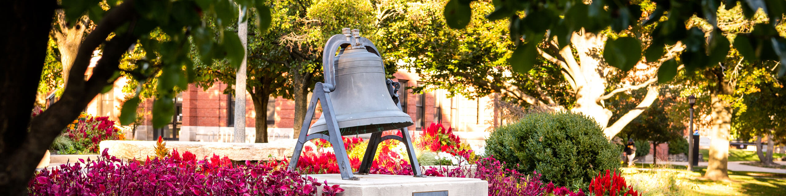 Flowers surround the Founder's Bell.